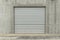 Metallic garage door in a grey industial wall