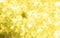 Metallic Gold yellow Lights Festive background. Abstract Christmas twinkled bright background with bokeh unfocused silver lights