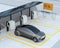 Metallic gray autonomous car recharging in parking lot