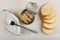 Metallic jar with canned pink salmon, plate and fork, pieces of bread on table. Top view