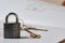 Metallic lock, keys and layout draft on apartment sale deal