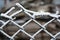 Metallic old rusty netting net decorated with white snow, bright hoarfrost and beautiful snowflakes.