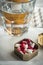 Metallic pillbox with white and red capsules along with water glass