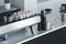 Metallic silver coffee machine and white coffee cups above. 3d rendering.