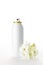Metallic spray bottle and flowers on the white background