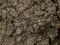 Metallic textured dark rough foil dirt stone with cracks background