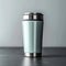 Metallic thermo cup with warm beverages, stainless steel container concept