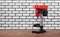 Metalwork tool - Red new drill press white brick wall background