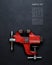 Metalwork tool - red vintage mechanical hand vise clamp on grey background. With copy space