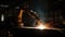 Metalworker welding steel with flame in industrial workshop generated by AI