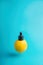 Metaphor, bottle with whey, butter in lemon. The concept of vitamin C in cosmetics and aromatherapy Levitation.