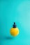 Metaphor, bottle with whey, butter in lemon. The concept of vitamin C in cosmetics and aromatherapy Levitation.