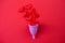 Metaphor of female menstrual cup collecting menstruation blood, isolated on red background