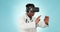 Metaverse, doctor or man with glasses for interaction on a blue background for futuristic healthcare. Hands, work and