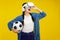 Metaverse sport concept, amazed asian girl football fan in VR headset holding soccer ball and trying to touch something with hands