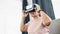 Metaverse and virtual reality concept, Asian elderly woman wearing VR glasses at home