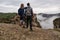 Meteora - Couple standing on cliff edge with scenic view of Holy Monastery of Varlaam, Kalambaka, Meteora