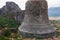 Meteora - Stone bell on top of rock Aghio Pnevma (Holy Spirit). Panoramic view on valley between village of Kastraki