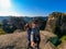 Meteora - A young couple taking a selfie with panoramic view of the Holy Monastery of Varlaam, Meteora, Greece.