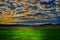 Meteorological photo - clouds over the meadow and agriculture fields at summer sunset.