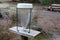 Meteorology filled rain gauge empty water meter with forest park background