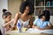 Metis woman doing tutoring with her children