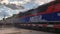 Metra train and freight train pass each other at the Villa Park train station in the suburbs of Chicago