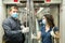 Metro passengers wearing personal protective equipment talking