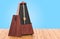 Metronome on the wooden table, 3D