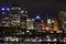 Metropolitan city with wharf and skyline by night