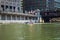 Metropolitan Water Reclamation District of Greater Chicago boat crosses the Chicago River by the Merchandise Mart as it cleans up