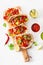 Mexican beef and pork tacos with salsa, guacamole and vegetables