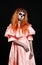 Mexican body art. God of death. Redhead girl in peachy dress. Woman monster. Creative dark make-up.