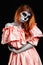 Mexican body art. God of death. Redhead girl in peachy dress. Woman monster. Creative dark make-up.