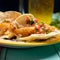 Mexican breaded fish tacos also called ensenada on turquoise background