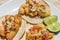 Mexican breaded shrimp tacos with sauce and lime