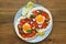 Mexican breakfast huevos rancheros: fried egg with salsa closeup in the pan