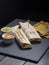 Mexican burritos with cheese sauces and guacamole with black background