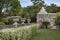 Mexican caribbean garden with temazcal, rustic stone and concrete decoration