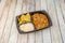 Mexican chicken tinga stew takeaway tray with white rice, corn chips, peas