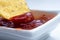 Mexican chips corn close-up dips in ketchup, hot chili sauce