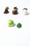 Mexican Colorful chocolate candy bonbons with mint leaves, cinnamon and coffee beans on white background