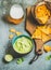 Mexican corn chips, fresh guacamole sauce and glass of beer