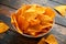 Mexican corn, tortilla cheese chips in a white cup on wooden table