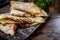 Mexican cuisine. Grilled quesadillas, tortillas with cheese, on wooden board.