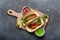 Mexican dish fajita tacos on wooden cutting board from above