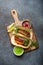 Mexican dish fajita tacos on wooden cutting board from above