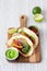 Mexican dish fajita tacos on wooden cutting board on white table