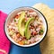 Mexican fish ceviche with avocado on blue background