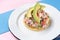 Mexican fish ceviche with avocado on colorful background